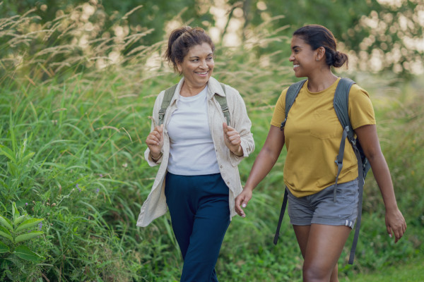 A mother and daughter hiking in the woods together