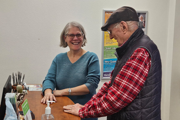 Rebecca Mooney of South Sound Audiology greets a patient at the front desk